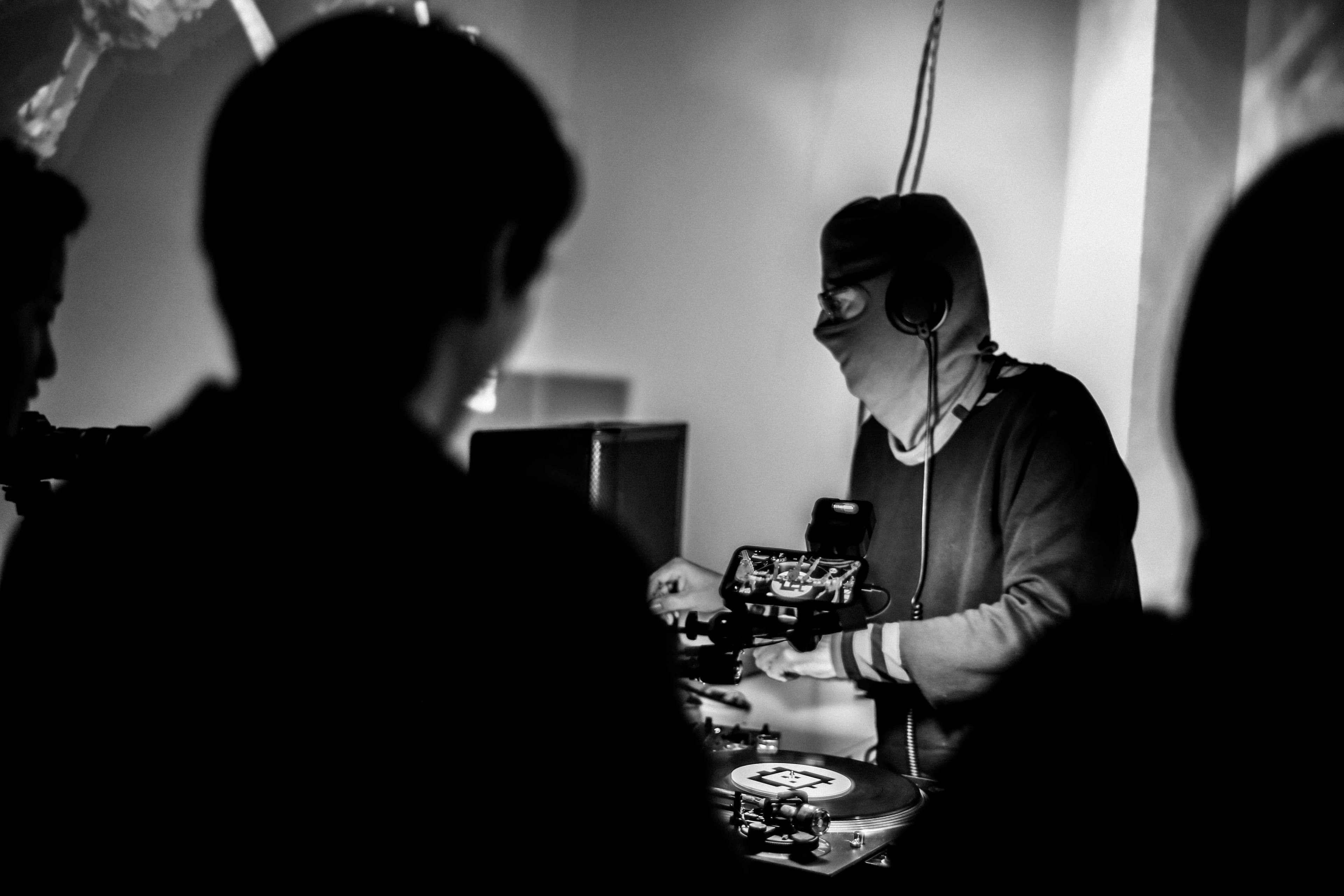 A black and white photo of a crowd watching Rob Ray DJ.