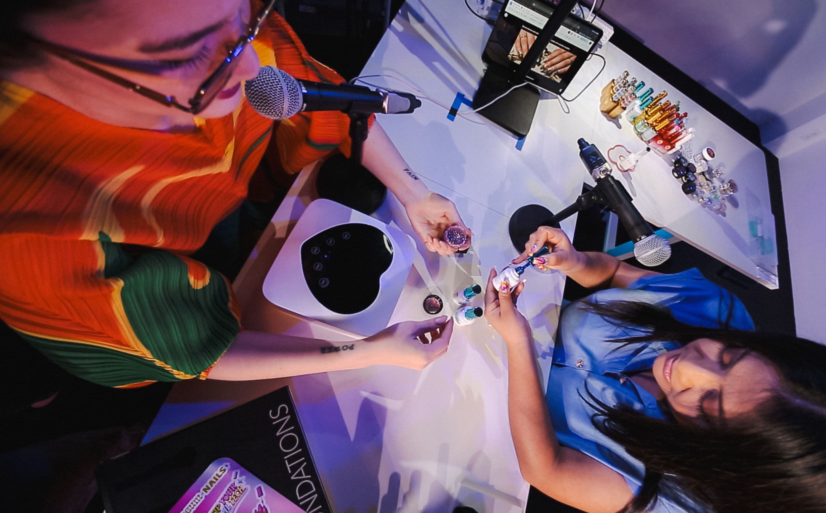 An over the head shot of someone doing Arabelle Sicardi's nails.
